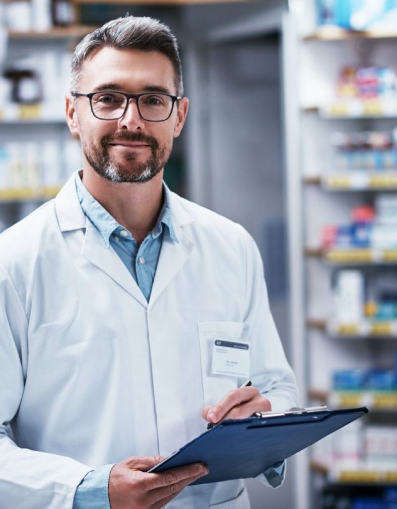 portrait-of-a-mature-pharmacist-writing-on-a-clipboard-in-a-pharmacy